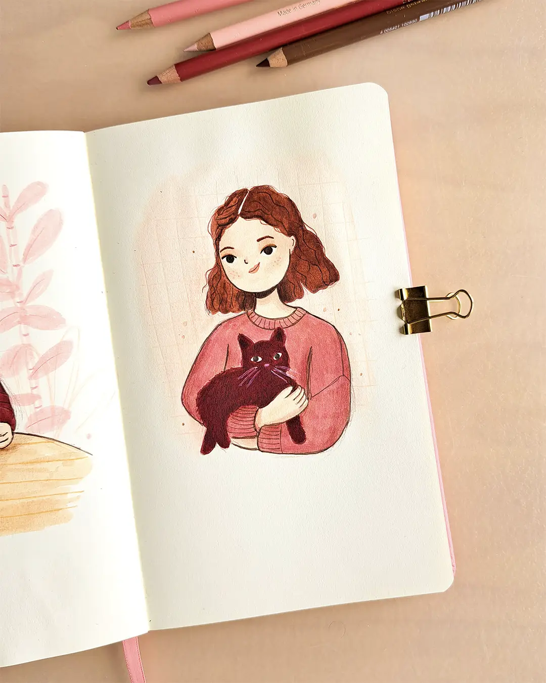 Page de carnet de croquis avec l'illustration d'une femme portant un chat dans ses bras.