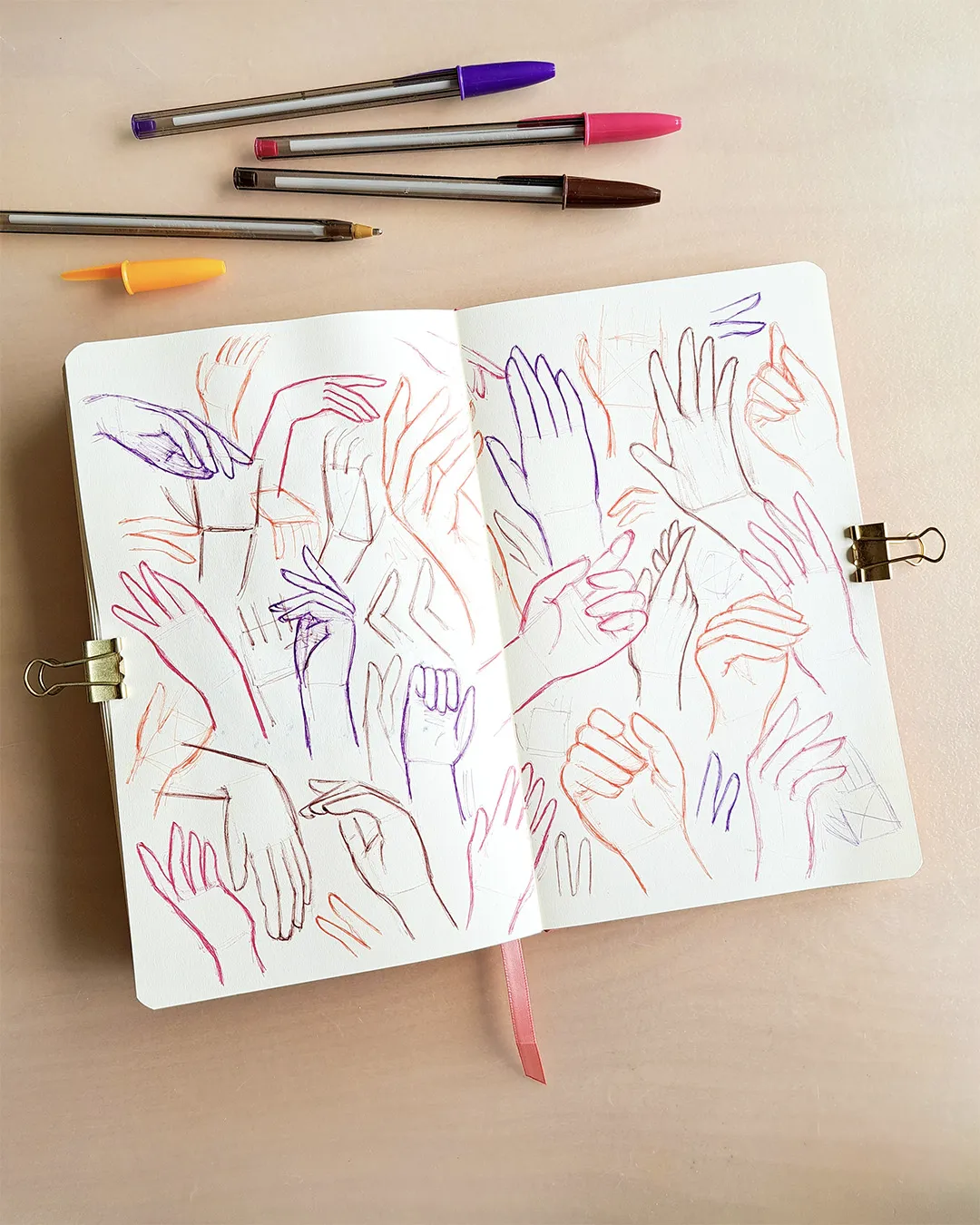 Pages de carnet avec différents croquis de mains.