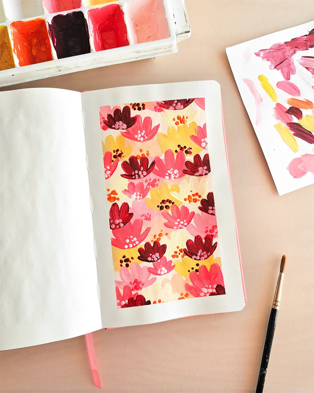 Page de carnet de croquis avec l'illustration d'un motif floral réalisé à l'acrylique, dans une palette de couleurs chaudes.